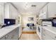 Updated kitchen featuring white cabinets, a blue tile backsplash, and stainless steel appliances at 707 2Nd Se St, Largo, FL 33771