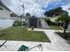 Landscaped backyard with shed and patio at 1847 Oak Lake Dr, Clearwater, FL 33764