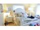 Charming bedroom with white furniture and floral bedding at 1847 Oak Lake Dr, Clearwater, FL 33764