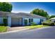 Front view of a single-story home with attached garage and well-maintained landscaping at 8356 Candlewood Rd # 0, Seminole, FL 33777