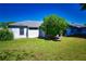 View of house exterior with neat lawn and mature tree at 8356 Candlewood Rd # 0, Seminole, FL 33777