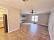 Spacious living room with wood-look floors and a ceiling fan at 8356 Candlewood Rd # 0, Seminole, FL 33777