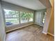 Bright sunroom with wood-look flooring, large windows, and a door to backyard at 8356 Candlewood Rd # 0, Seminole, FL 33777