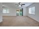 Spacious living area with carpet, ceiling fan, and access to balcony at 635 Fairmont Ave # D, Safety Harbor, FL 34695