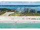 Expansive beach view of waterfront condos on the shore, with city skyline in the background at 1170 Gulf Blvd # 1005, Clearwater Beach, FL 33767