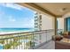 Enjoy ocean views from the tiled balcony with furniture at 1170 Gulf Blvd # 1005, Clearwater Beach, FL 33767