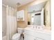 Bright bathroom featuring a large mirror, white vanity, and shower with a white curtain at 1170 Gulf Blvd # 1005, Clearwater Beach, FL 33767