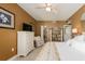 Relaxing bedroom features tiled floors, dresser, ceiling fan, and an ensuite closet and bathroom at 1170 Gulf Blvd # 1005, Clearwater Beach, FL 33767