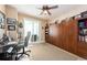 Bedroom with a murphy bed, desk, ceiling fan, and sliding glass doors leading to a balcony at 1170 Gulf Blvd # 1005, Clearwater Beach, FL 33767