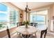 Bright dining area with balcony, ocean views, and seating for four at 1170 Gulf Blvd # 1005, Clearwater Beach, FL 33767