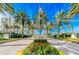 Beautiful entrance to the Grande community with mature palm trees and manicured landscaping at 1170 Gulf Blvd # 1005, Clearwater Beach, FL 33767