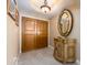 An entryway with a decorative table, an oval mirror, and double doors at 1170 Gulf Blvd # 1005, Clearwater Beach, FL 33767