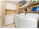 Functional laundry room with a sink, cabinetry, and modern washer and dryer at 1170 Gulf Blvd # 1005, Clearwater Beach, FL 33767