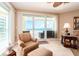 Relaxing seating area with a comfortable chair and a view of the balcony at 1170 Gulf Blvd # 1005, Clearwater Beach, FL 33767