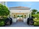 Outdoor kitchen with built-in grills and shaded dining area by the pool at 1170 Gulf Blvd # 1005, Clearwater Beach, FL 33767