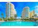 A stunning waterfront pool sits between high-rise buildings under a clear blue sky at 1170 Gulf Blvd # 1005, Clearwater Beach, FL 33767