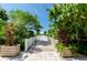 Picturesque walkway with lush greenery leading towards the beach at 1170 Gulf Blvd # 1005, Clearwater Beach, FL 33767