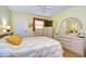 Bedroom with wood floors, a queen bed, and ample closet space at 1893 Shore S Dr # 206, South Pasadena, FL 33707