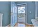 Condo entryway with light blue door and wood floors at 1893 Shore S Dr # 206, South Pasadena, FL 33707