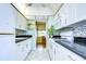 White kitchen with granite countertops and stainless steel appliances at 1893 Shore S Dr # 206, South Pasadena, FL 33707