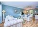 Living room with light blue walls, wood floors, and sofas at 1893 Shore S Dr # 206, South Pasadena, FL 33707
