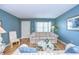 Living Room with light blue walls, wood floors, and sofas at 1893 Shore S Dr # 206, South Pasadena, FL 33707