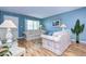Living room with light blue walls, wood floors, and sofas at 1893 Shore S Dr # 206, South Pasadena, FL 33707