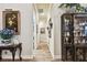 Hallway with hardwood floors, artwork, and display cabinet at 23 Concord Dr, Dunedin, FL 34698