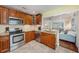 Kitchen with wood cabinets, granite counters, and stainless steel appliances at 2827 29Th N Ave, St Petersburg, FL 33713