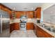 Modern kitchen with wood cabinets and stainless steel appliances at 2827 29Th N Ave, St Petersburg, FL 33713