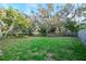 Spacious backyard with mature trees and lush green grass at 219 6Th Sw Ave, Largo, FL 33770