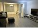 Bright living room featuring hardwood floors and a large TV at 219 6Th Sw Ave, Largo, FL 33770