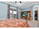 Bedroom features a balcony, entertainment center, closet, crown molding, and a ceiling fan at 435 Westwinds Drive, Palm Harbor, FL 34683