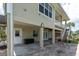 Ground floor outdoor patio and entertainment area with brick pavers and access to stairs and boat dock at 435 Westwinds Drive, Palm Harbor, FL 34683