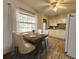 This dining room features a wooden table set for four near the window, next to the kitchen at 1345 Young Ave, Clearwater, FL 33756