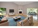 Spacious living room featuring tile floors, modern furniture, and a beautiful fireplace at 903 San Carlos Ne Ave, St Petersburg, FL 33702