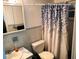 Cozy main bathroom with vanity, toilet, and shower with stylish curtain at 2528 Almond Dr, Holiday, FL 34691