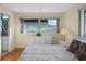 Bright bedroom with wood floors, dresser, and a comfortable king-size bed at 7030 Lafayette N, Pinellas Park, FL 33781