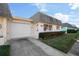 Cute and cozy yellow exterior with a gray roof and well-manicured lawn at 7030 Lafayette N, Pinellas Park, FL 33781