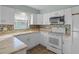 Well-equipped kitchen featuring white cabinets and stainless steel appliances at 7030 Lafayette N, Pinellas Park, FL 33781