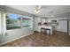 Eat-in kitchen with white cabinets, tile floor, and view of backyard at 7030 Lafayette N, Pinellas Park, FL 33781