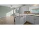 Modern kitchen with white cabinets, tile backsplash, and a breakfast bar at 7030 Lafayette N, Pinellas Park, FL 33781