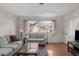 Bright living room with hardwood floors, comfy sofas, and a large window at 7030 Lafayette N, Pinellas Park, FL 33781