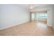 Bedroom with tile floors, a ceiling fan, and sliding glass doors to a balcony at 100 Bluff View Dr # 405C, Belleair Bluffs, FL 33770