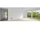 Bright bedroom with large windows and view of the tennis courts at 3021 Countryside Blvd # 28A, Clearwater, FL 33761
