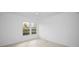 Well-lit bedroom with neutral carpeting and a window view at 3021 Countryside Blvd # 28A, Clearwater, FL 33761