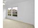 Bedroom with large windows offering a view of the community at 3021 Countryside Blvd # 28A, Clearwater, FL 33761