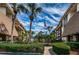 Condo community entrance with lush landscaping and flagpole at 3021 Countryside Blvd # 28A, Clearwater, FL 33761