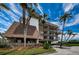 Exterior view of condo building with palm trees and parking at 3021 Countryside Blvd # 28A, Clearwater, FL 33761