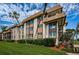 Condo building with well-maintained grounds and palm trees at 3021 Countryside Blvd # 28A, Clearwater, FL 33761